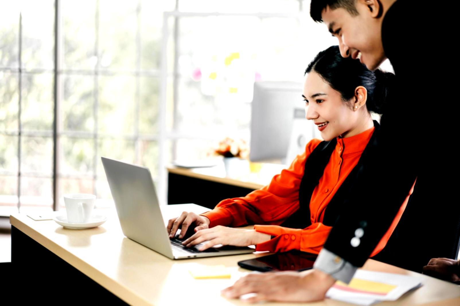 Professional email marketing workspace with analytics dashboard and campaign planning materials